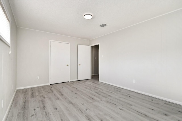 interior space with light hardwood / wood-style floors and a textured ceiling