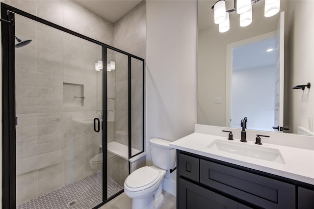 bathroom featuring vanity, toilet, and walk in shower