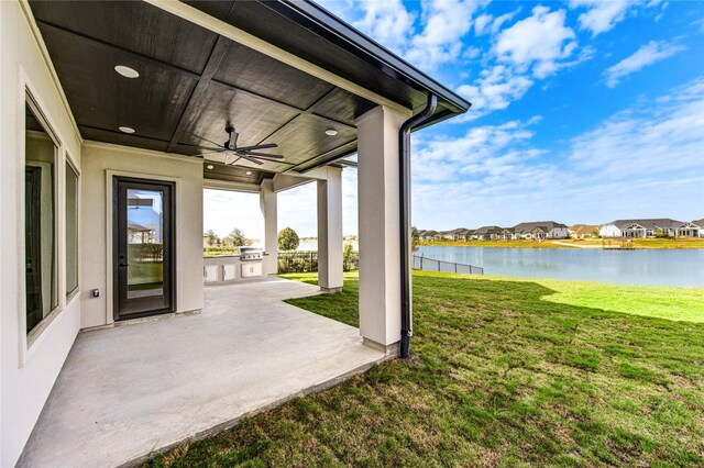 view of patio / terrace with ceiling fan and a water view