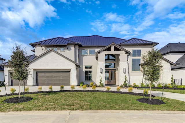 view of front of property featuring a front lawn and a garage