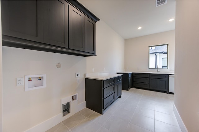 laundry room featuring cabinets, washer hookup, hookup for an electric dryer, light tile patterned floors, and hookup for a gas dryer