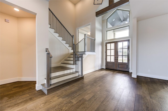 entryway with hardwood / wood-style floors, high vaulted ceiling, and french doors