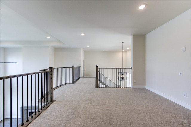 interior space featuring light colored carpet and a notable chandelier