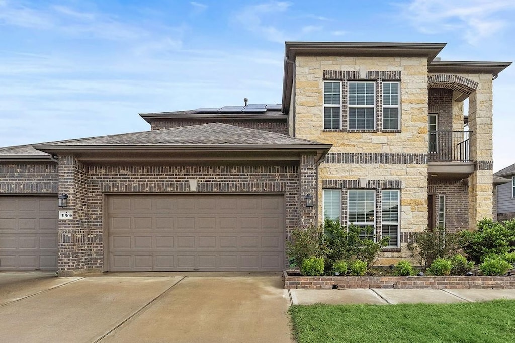 view of front of home featuring a garage and solar panels