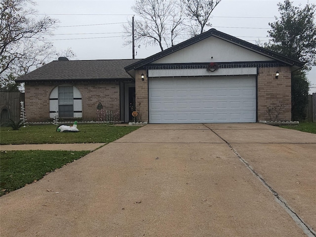 ranch-style house featuring a front yard and a garage