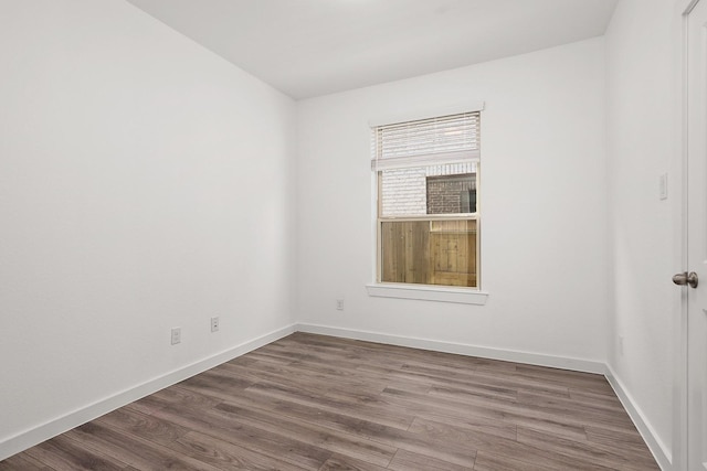 unfurnished room featuring dark wood-type flooring