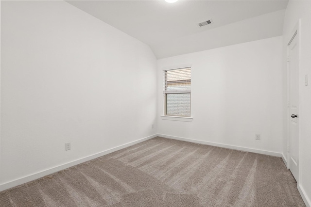 empty room with carpet and lofted ceiling