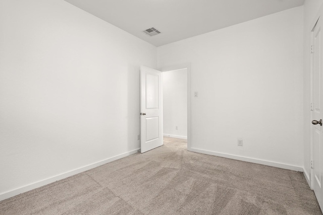 unfurnished room featuring light colored carpet