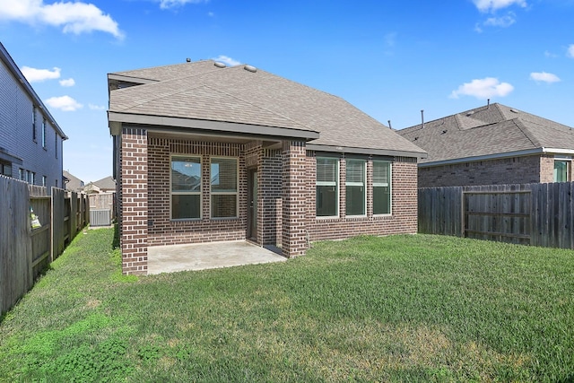 rear view of house with a lawn and a patio area