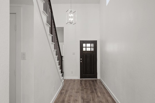 entryway featuring dark hardwood / wood-style flooring and an inviting chandelier