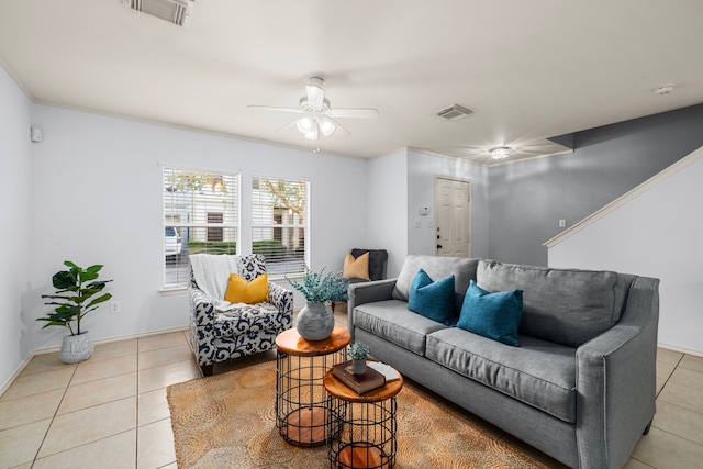 tiled living room featuring ceiling fan and ornamental molding