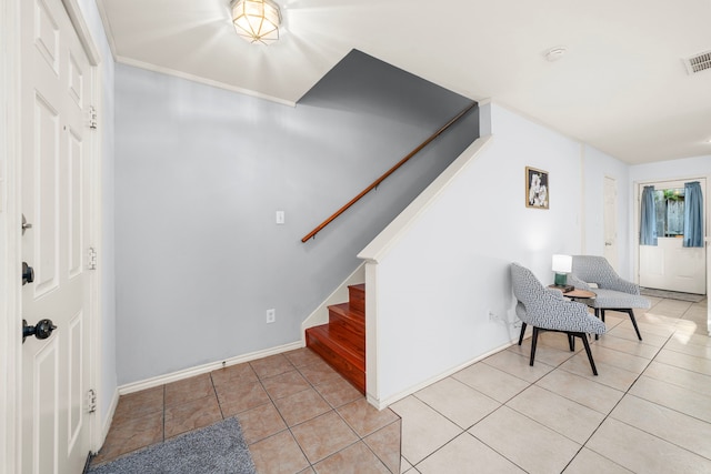 foyer entrance with light tile patterned floors