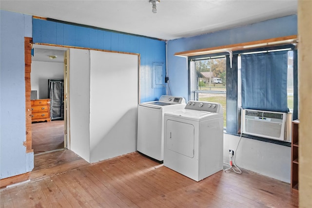 laundry area with hardwood / wood-style floors, cooling unit, and separate washer and dryer