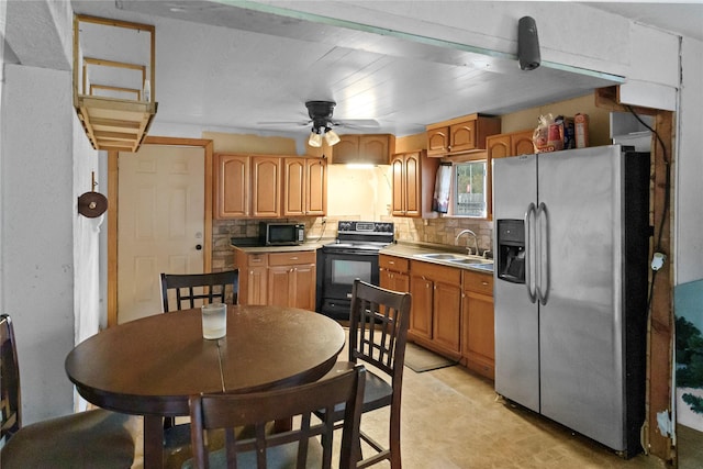 kitchen featuring backsplash, ceiling fan, sink, and black appliances