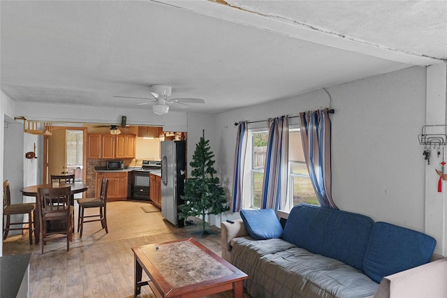 living room featuring ceiling fan and light hardwood / wood-style flooring