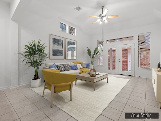 tiled living room featuring ceiling fan and french doors