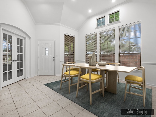 tiled dining area with ornamental molding, high vaulted ceiling, and french doors