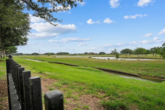 view of yard with a water view and a rural view