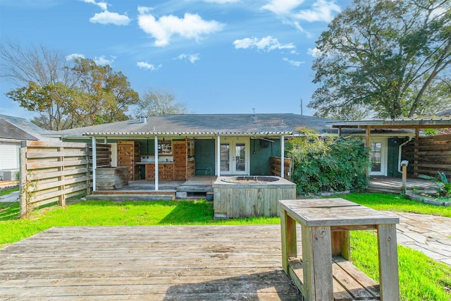 back of property featuring a wooden deck and french doors