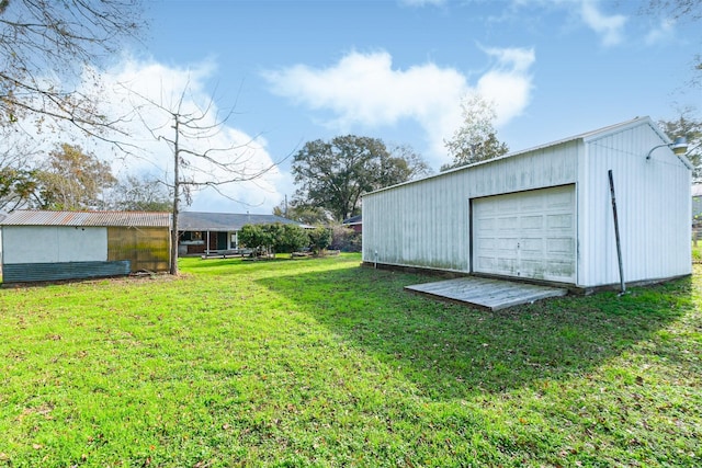 view of yard with an outbuilding and a garage