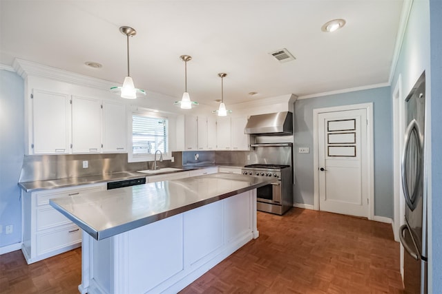 kitchen with pendant lighting, wall chimney exhaust hood, stainless steel counters, white cabinetry, and stainless steel appliances