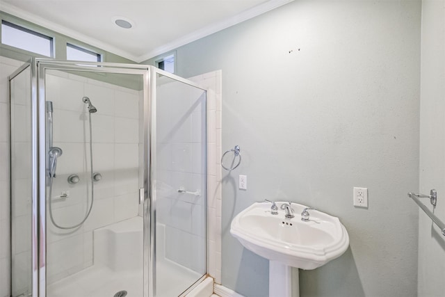 bathroom featuring sink, crown molding, lofted ceiling, and walk in shower