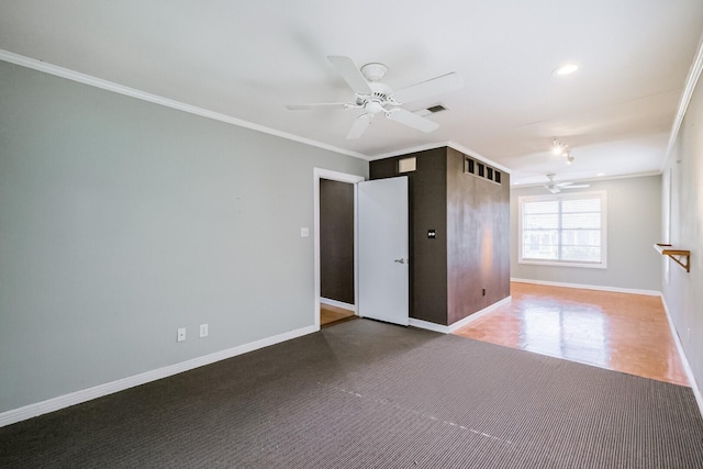 empty room with ceiling fan and crown molding