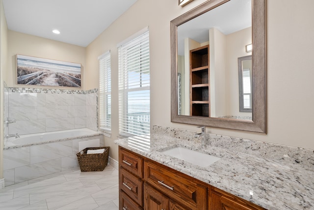 bathroom featuring a tub and vanity