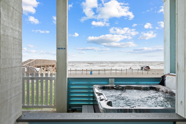 exterior space with a water view and a beach view