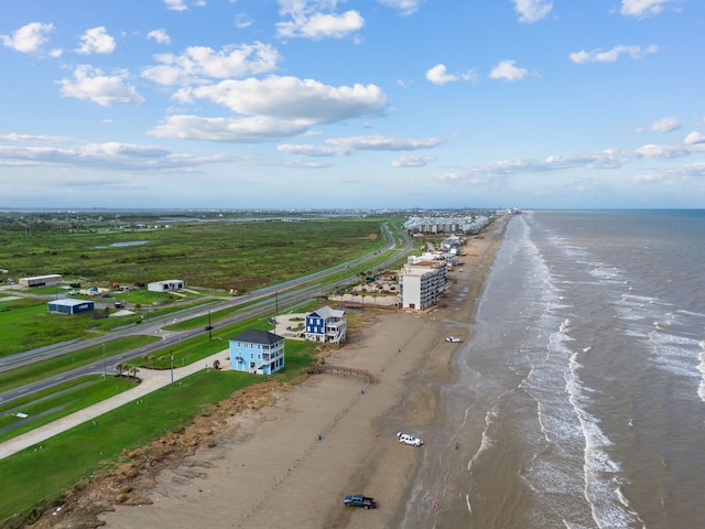 birds eye view of property with a water view and a view of the beach