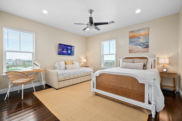 bedroom with ceiling fan and dark hardwood / wood-style flooring