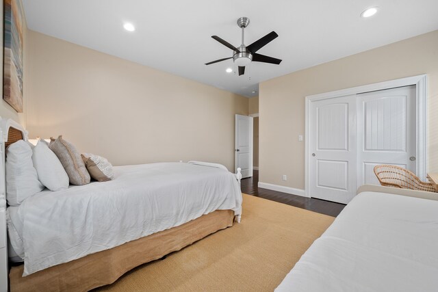 bedroom with a closet, ceiling fan, and dark wood-type flooring