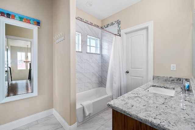 bathroom featuring a healthy amount of sunlight, vanity, and shower / bath combo with shower curtain