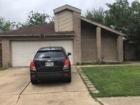 garage featuring a lawn