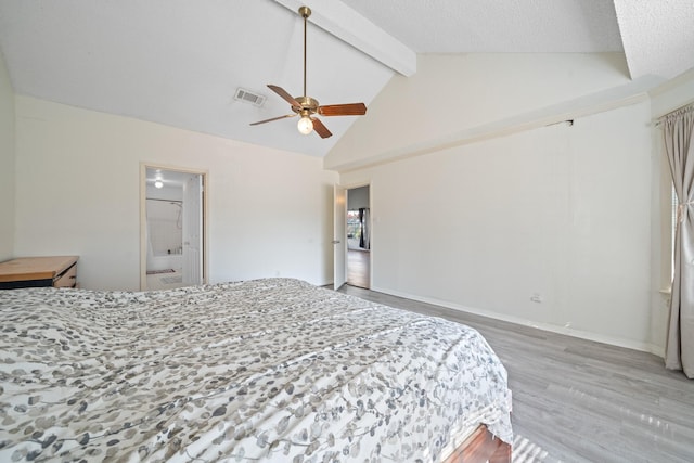 bedroom featuring lofted ceiling with beams, ensuite bathroom, ceiling fan, a textured ceiling, and wood-type flooring