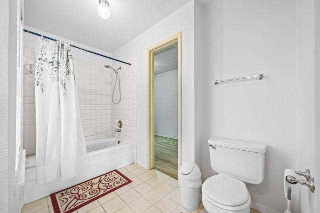 bathroom with tile patterned flooring, toilet, and shower / bath combo with shower curtain