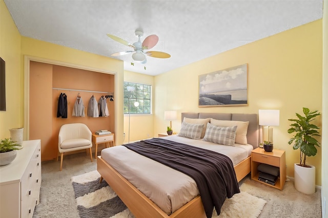 bedroom with light carpet, a closet, and ceiling fan