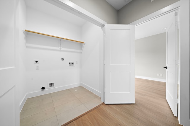 clothes washing area featuring gas dryer hookup, hookup for a washing machine, light wood-type flooring, and hookup for an electric dryer