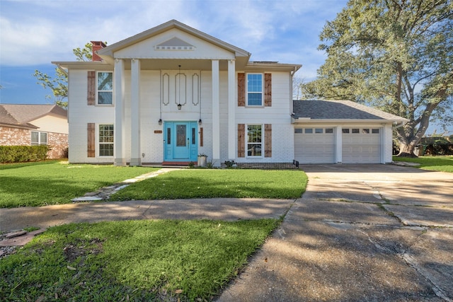 greek revival house with a front yard and a garage