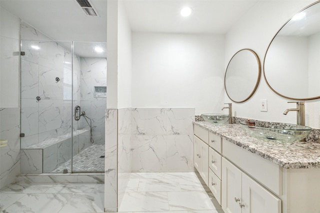 bathroom featuring vanity and a shower with shower door