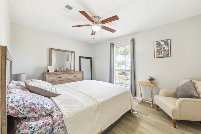 bedroom with ceiling fan and light wood-type flooring