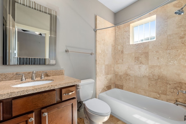 full bathroom with vanity, tiled shower / bath, and toilet