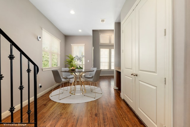 dining room with dark hardwood / wood-style floors and a wealth of natural light