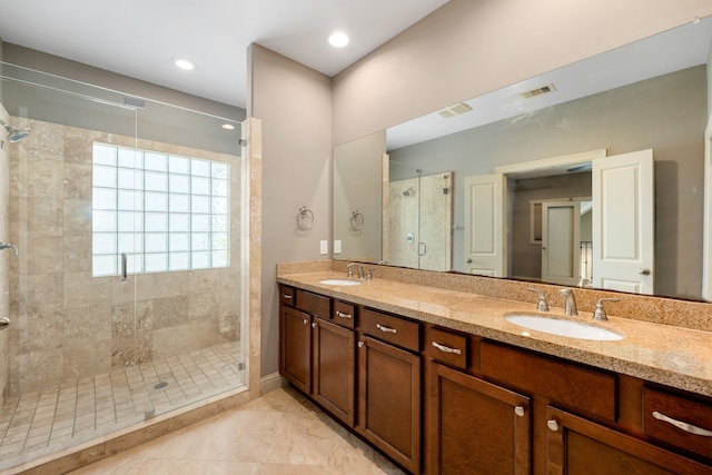 bathroom with tile patterned flooring, vanity, and a shower with door