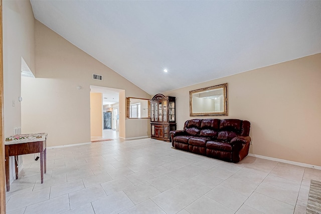 living room with light tile patterned floors and high vaulted ceiling