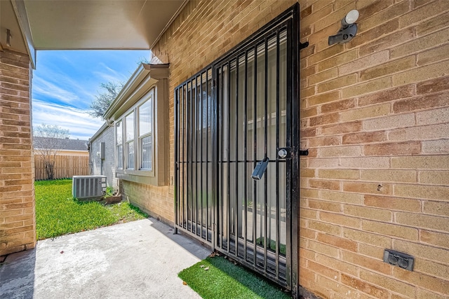 doorway to property featuring a patio and central AC unit