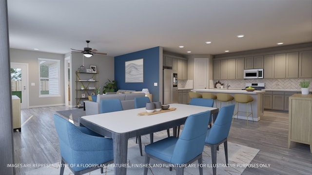 dining space with ceiling fan and light wood-type flooring