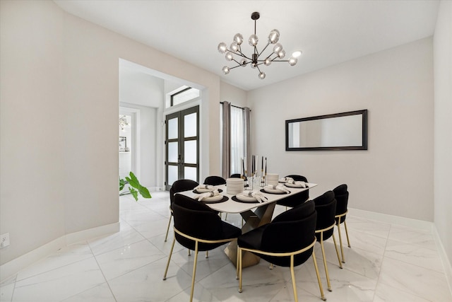 dining space with an inviting chandelier, baseboards, marble finish floor, and french doors