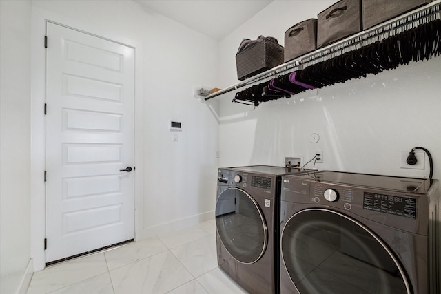 laundry area featuring laundry area, separate washer and dryer, and baseboards