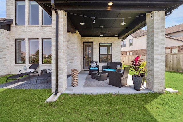 view of patio / terrace with a ceiling fan, an outdoor living space, and fence